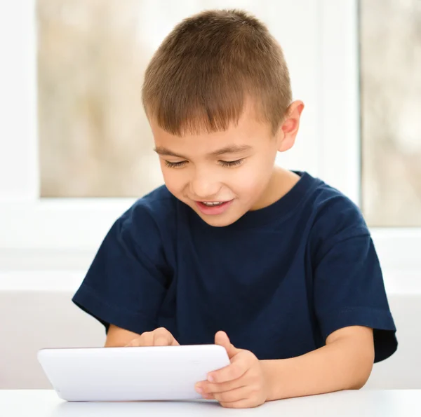 Niño joven está usando tableta — Foto de Stock