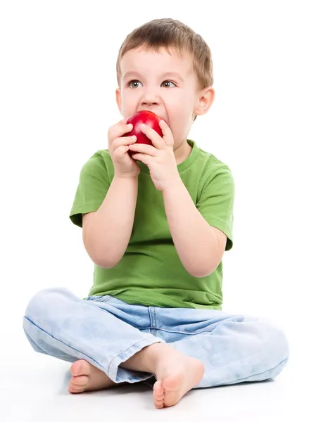 Portrait of a cute little boy with red apple — Stock Photo, Image