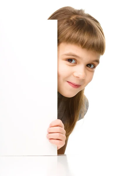 La ragazzina sta guardando fuori dal banner bianco — Foto Stock