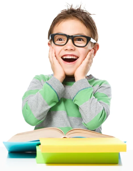 Astonished little boy is reading a book — Stock Photo, Image