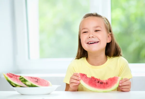 Cute little girl is eating watermelon — Stock Photo, Image