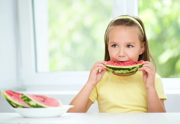 Cute little girl is eating watermelon — Stock Photo, Image