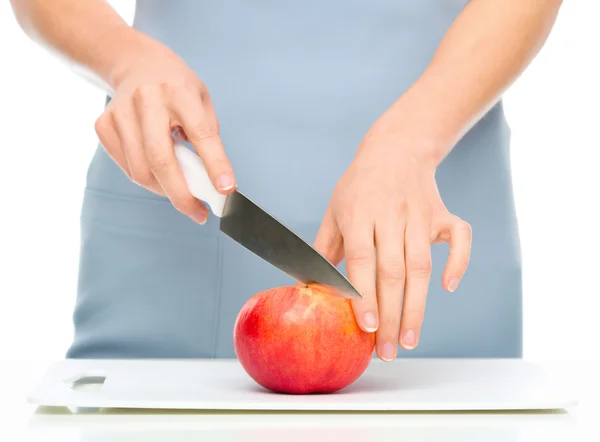 Cook is chopping apple — Stock Photo, Image