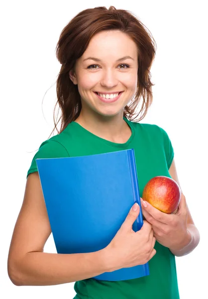 Fiatal diák lány a gazdaság, a könyv és az apple — Stock Fotó
