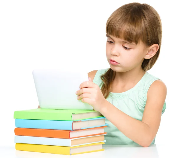 Young cheerful girl is using tablet — Stock Photo, Image