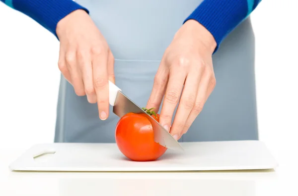 Cook is chopping red tomato — Stock Photo, Image