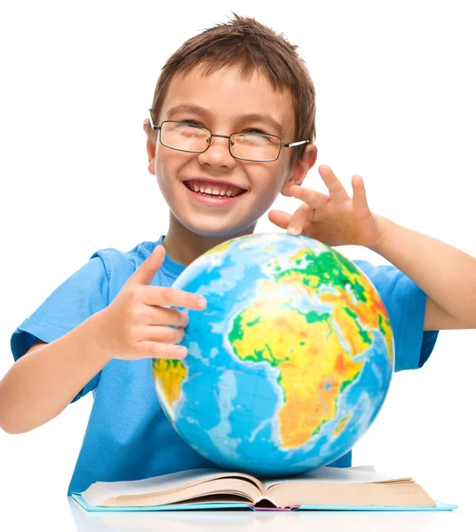 Menino está examinando globo — Fotografia de Stock