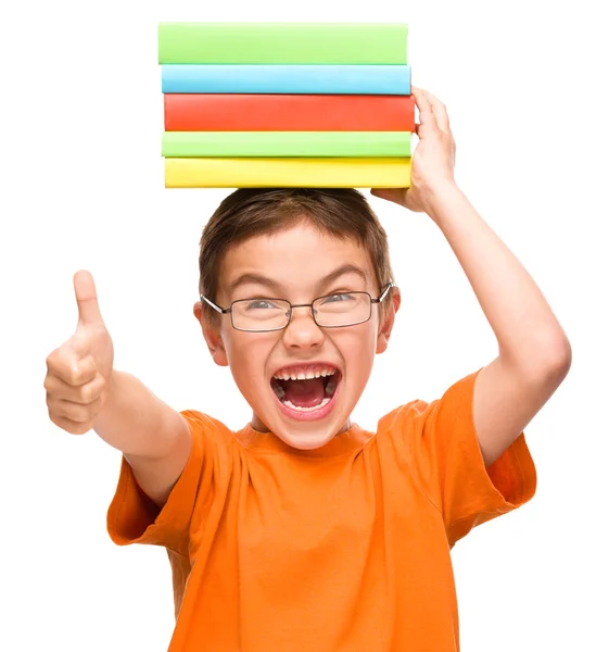 Little boy is holding a pile of books — Stock Photo, Image