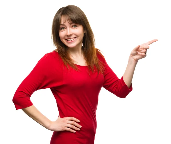 Portrait of a young woman pointing to the right — Stock Photo, Image