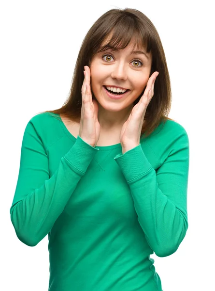 Woman is holding her face in astonishment — Stock Photo, Image