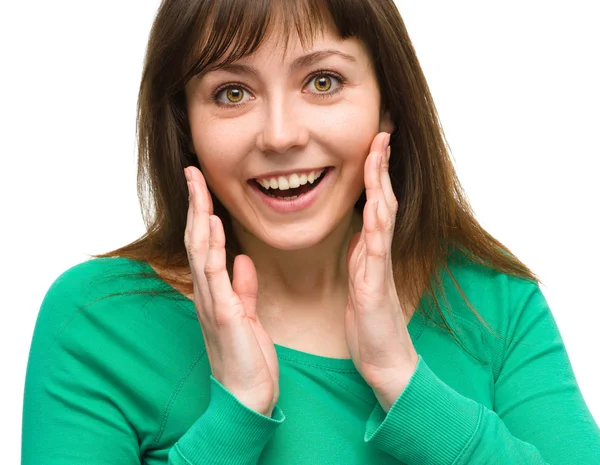 Woman is holding her face in astonishment — Stock Photo, Image