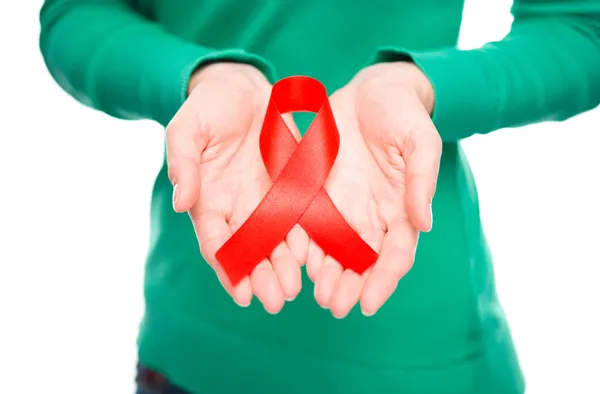 Woman is holding the red awareness ribbon — Stock Photo, Image