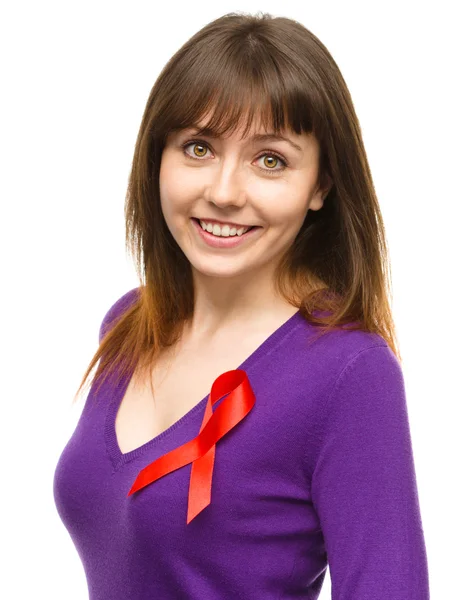 Woman with the red awareness ribbon — Stock Photo, Image