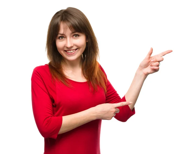 Portrait of a young woman pointing to the right — Stock Photo, Image