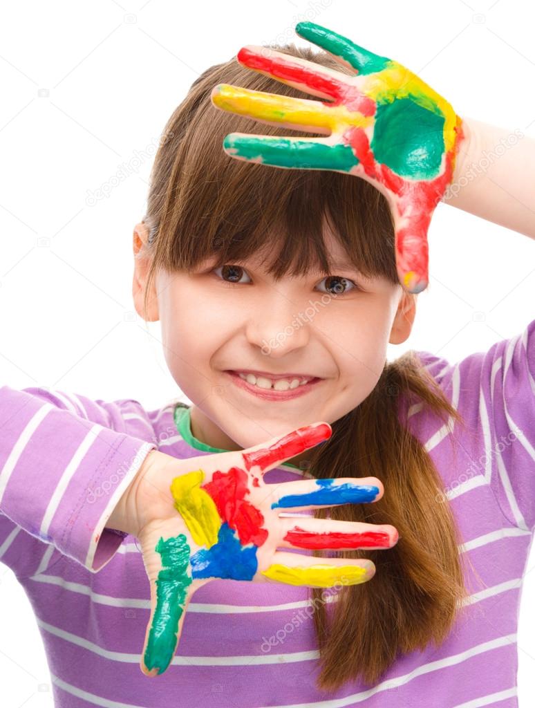 Portrait of a cute girl playing with paints