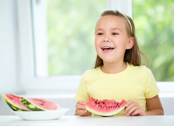 Cute little girl is eating watermelon — Stock Photo, Image