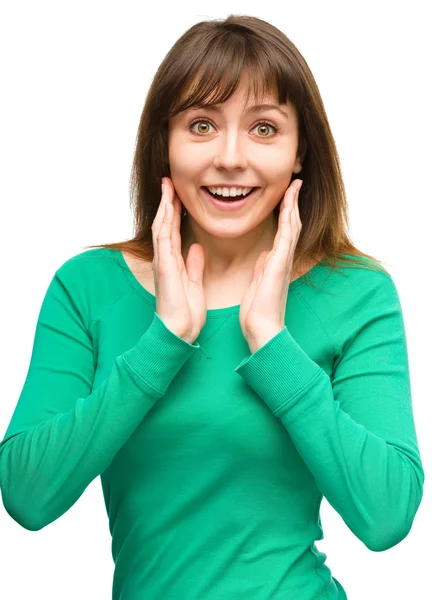 Woman is holding her face in astonishment — Stock Photo, Image