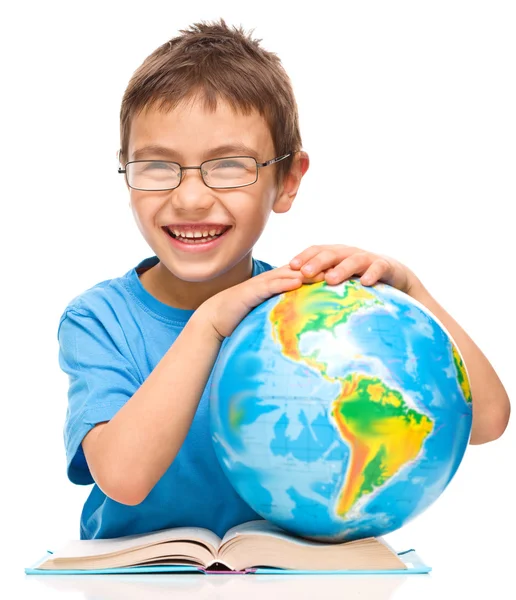 Kleine jongen bestudeert globe — Stockfoto