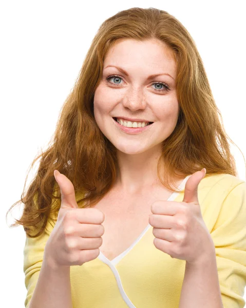 Woman is showing thumb up gesture Stock Image