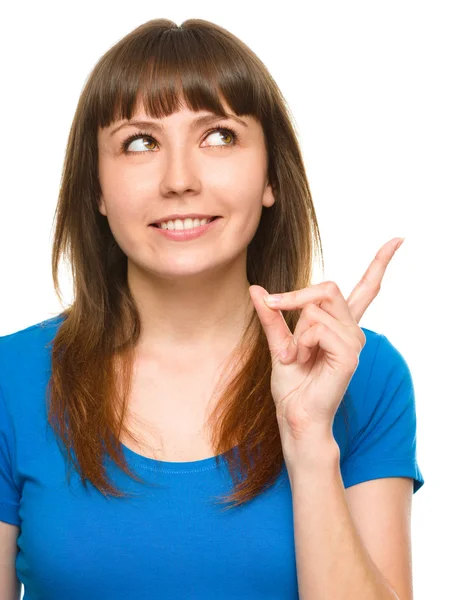 Portrait of a young woman pointing to the right — Stock Photo, Image