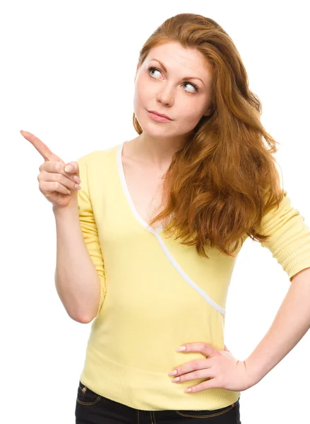 Portrait of a young woman pointing to the left Stock Image