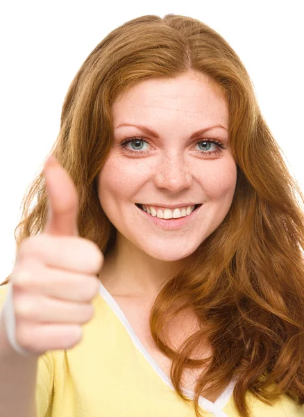 Woman is showing thumb up gesture Stock Image