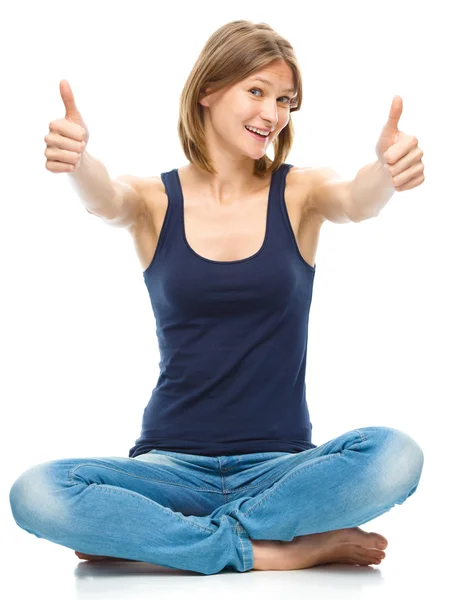 Young happy woman is showing thumb up sign — Stock Photo, Image