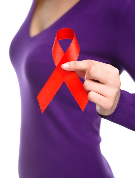 Woman is holding the red awareness ribbon — Stock Photo, Image