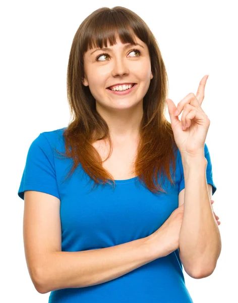 Portrait of a young woman pointing to the right — Stock Photo, Image