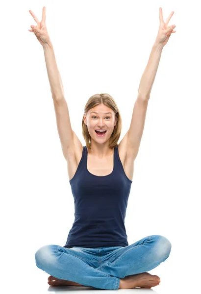 Young happy woman is sitting on the floor — Stock Photo, Image