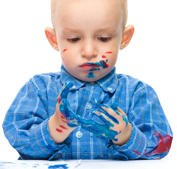 Little boy is playing with paints — Stock Photo, Image