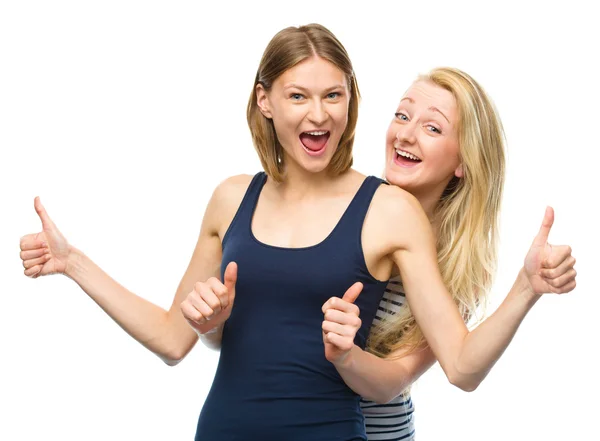 Two young happy women showing thumb up sign — Stock Photo, Image