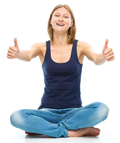 Young happy woman is showing thumb up sign — Stock Photo, Image