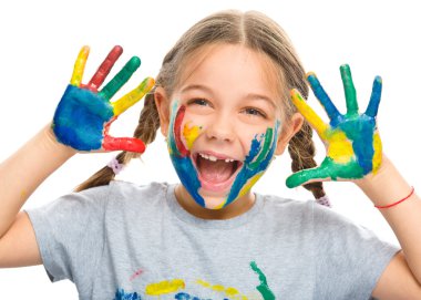 Portrait of a cute girl playing with paints clipart