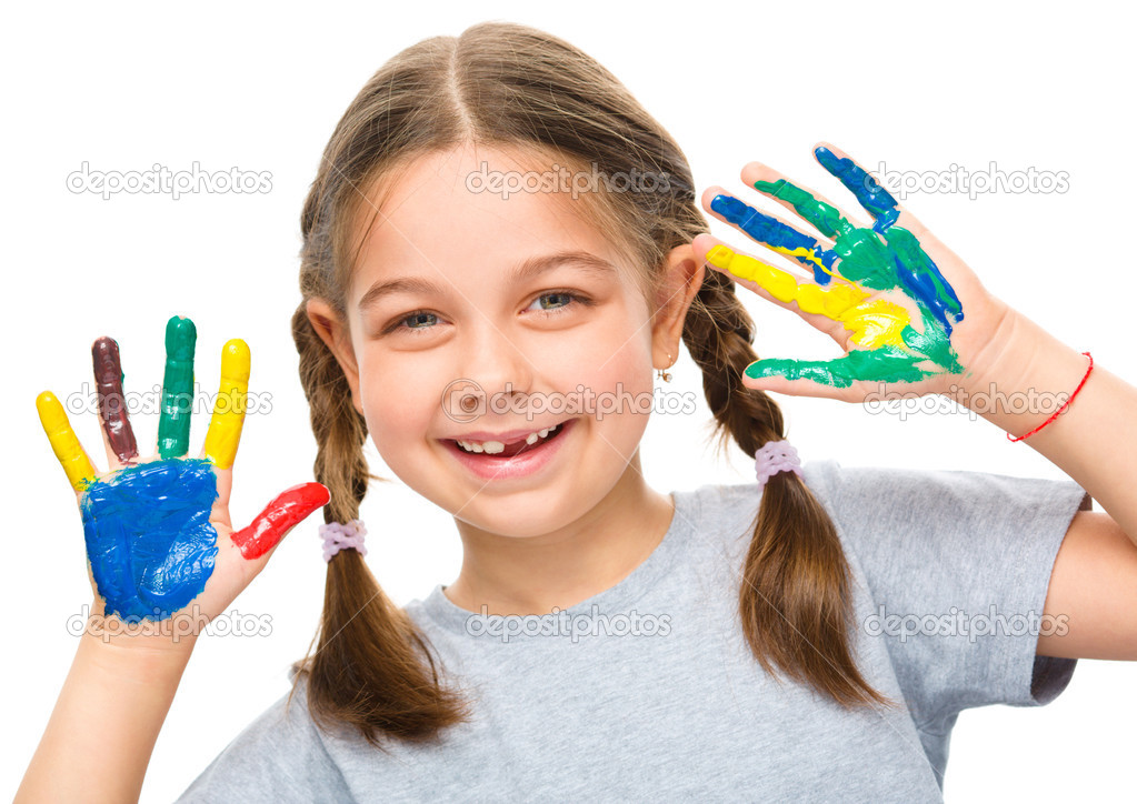 Portrait of a cute girl playing with paints