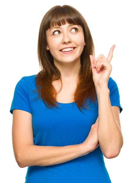 Portrait of a young woman pointing to the right — Stock Photo, Image