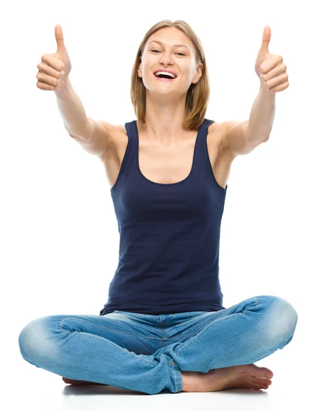 Young happy woman is showing thumb up sign — Stock Photo, Image