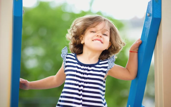 Cute little girl is playing in playground — Stock Photo, Image