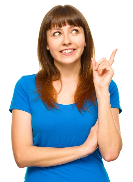 Portrait of a young woman pointing to the right — Stock Photo, Image