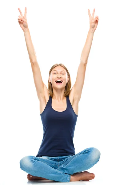 Young happy woman is sitting on the floor — Stock Photo, Image