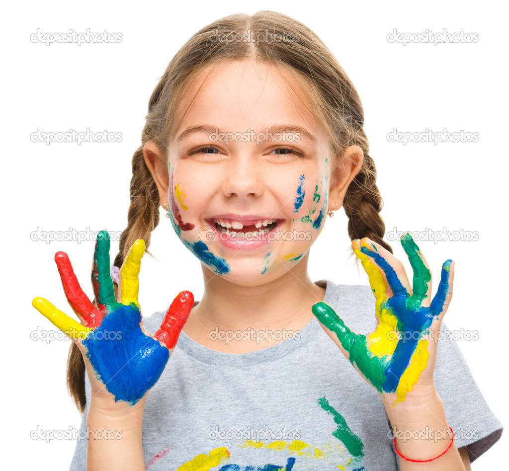 Portrait of a cute girl playing with paints