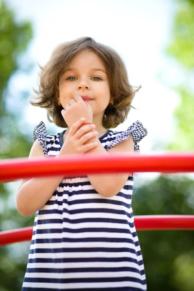 Cute little girl is playing in playground — Stock Photo, Image