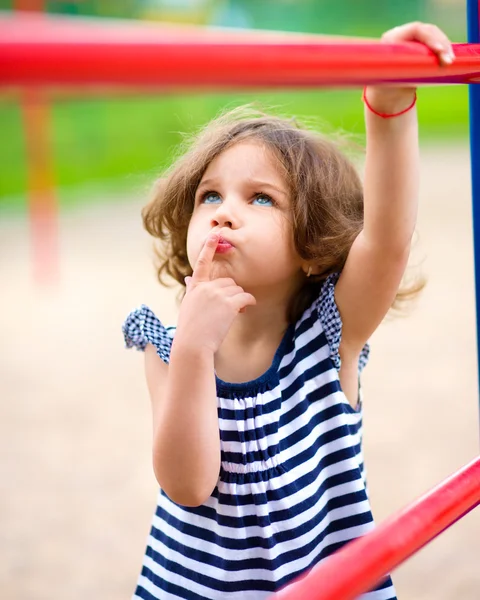 Милая маленькая девочка играет на детской площадке — стоковое фото
