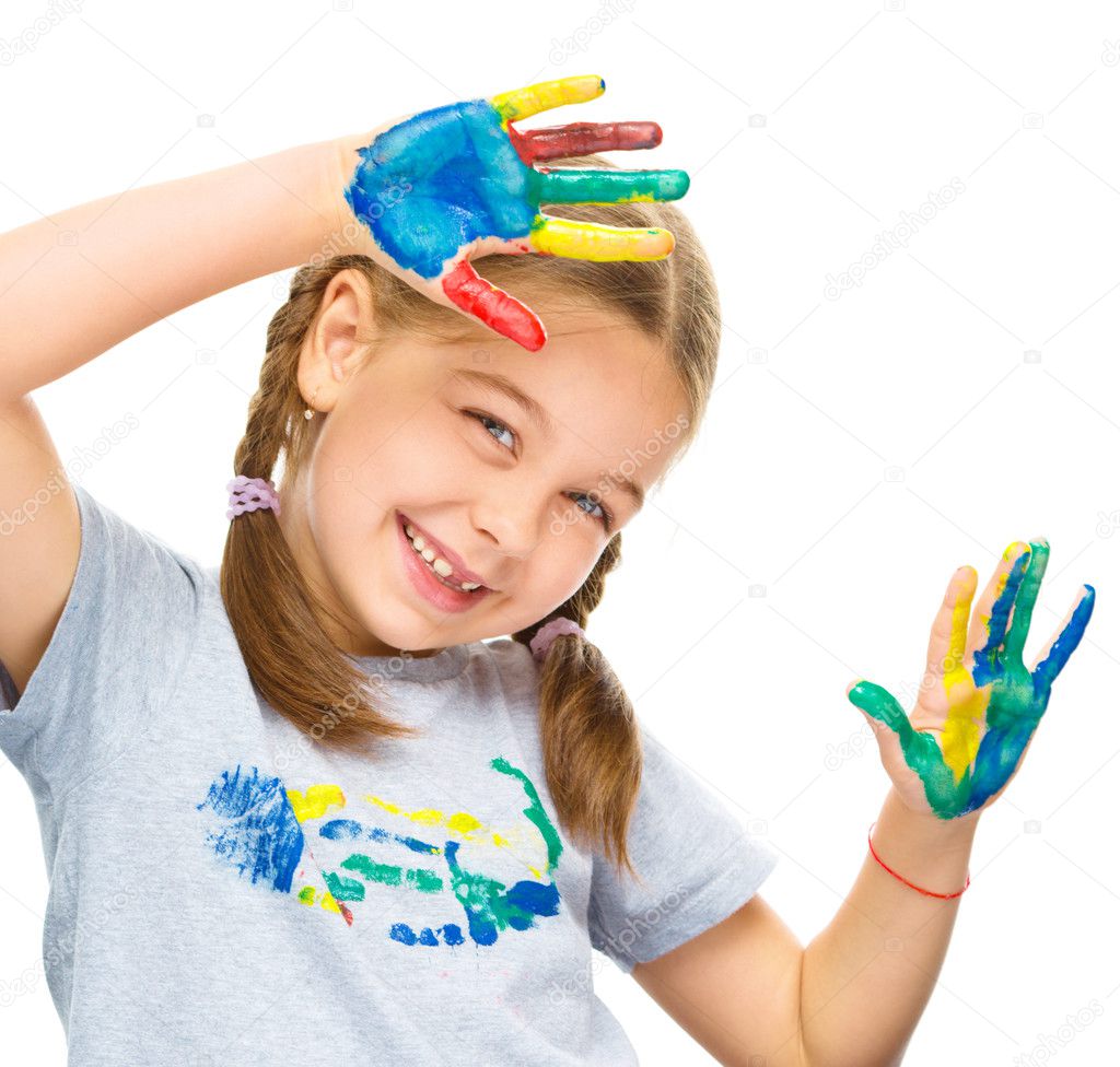 Portrait of a cute girl playing with paints