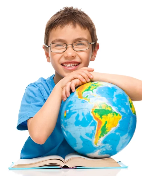 Menino está examinando globo — Fotografia de Stock