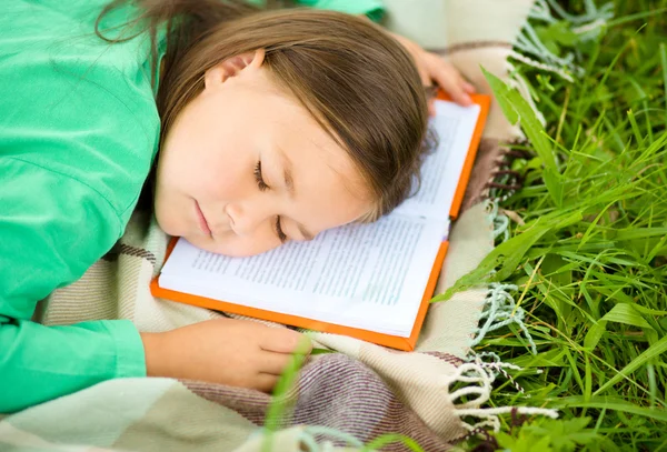 Girl is sleeping on her book outdoors — Stock Photo, Image