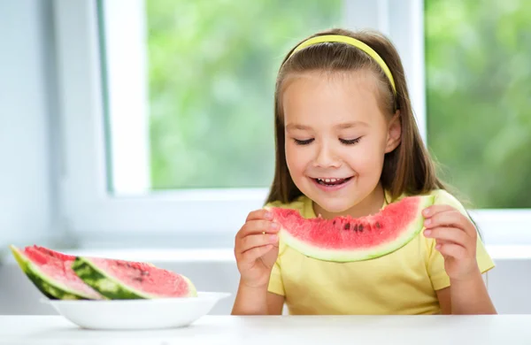 Cute little girl is eating watermelon — Stock Photo, Image