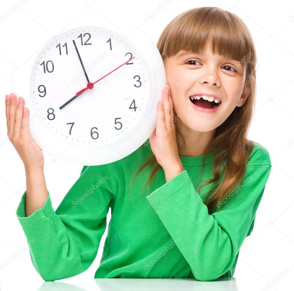 Little girl is holding big clock