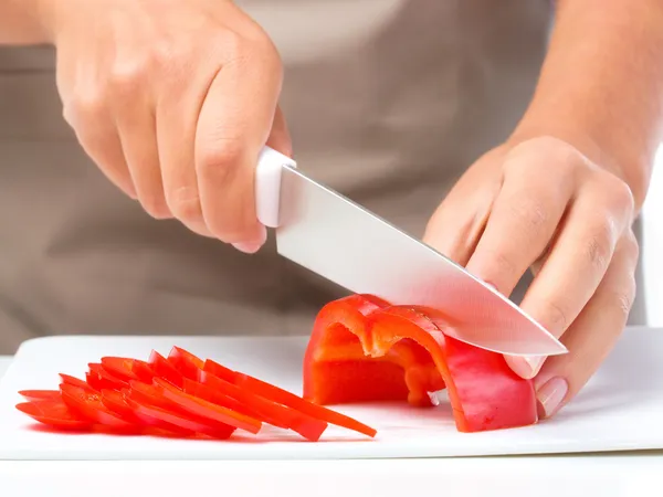 Cook is chopping bell pepper — Stock Photo, Image