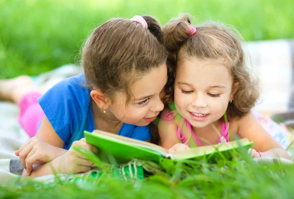 Two little girls are reading book Royalty Free Stock Images